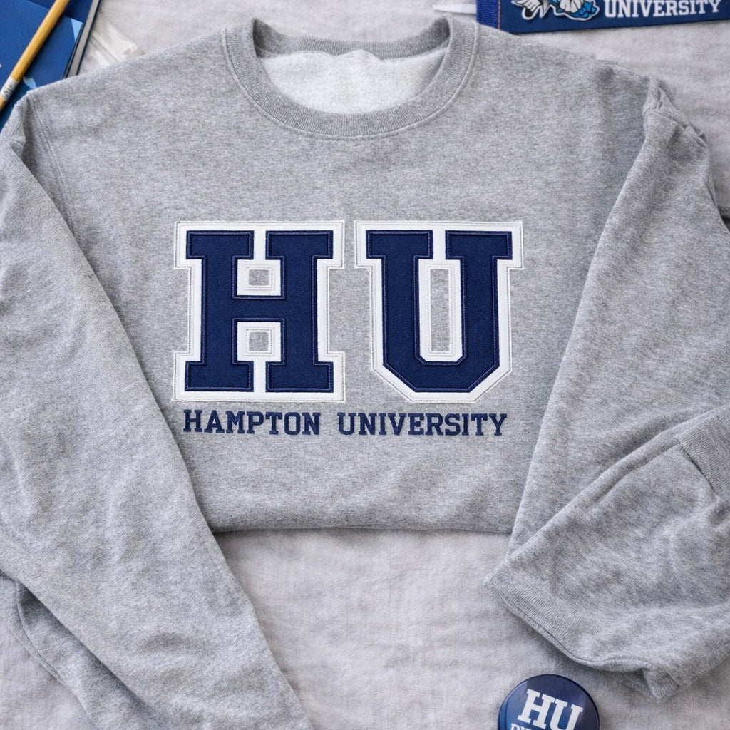 Sweatshirt featuring HU Hampton University with varsity style lettering on a gray crewneck hoodie.