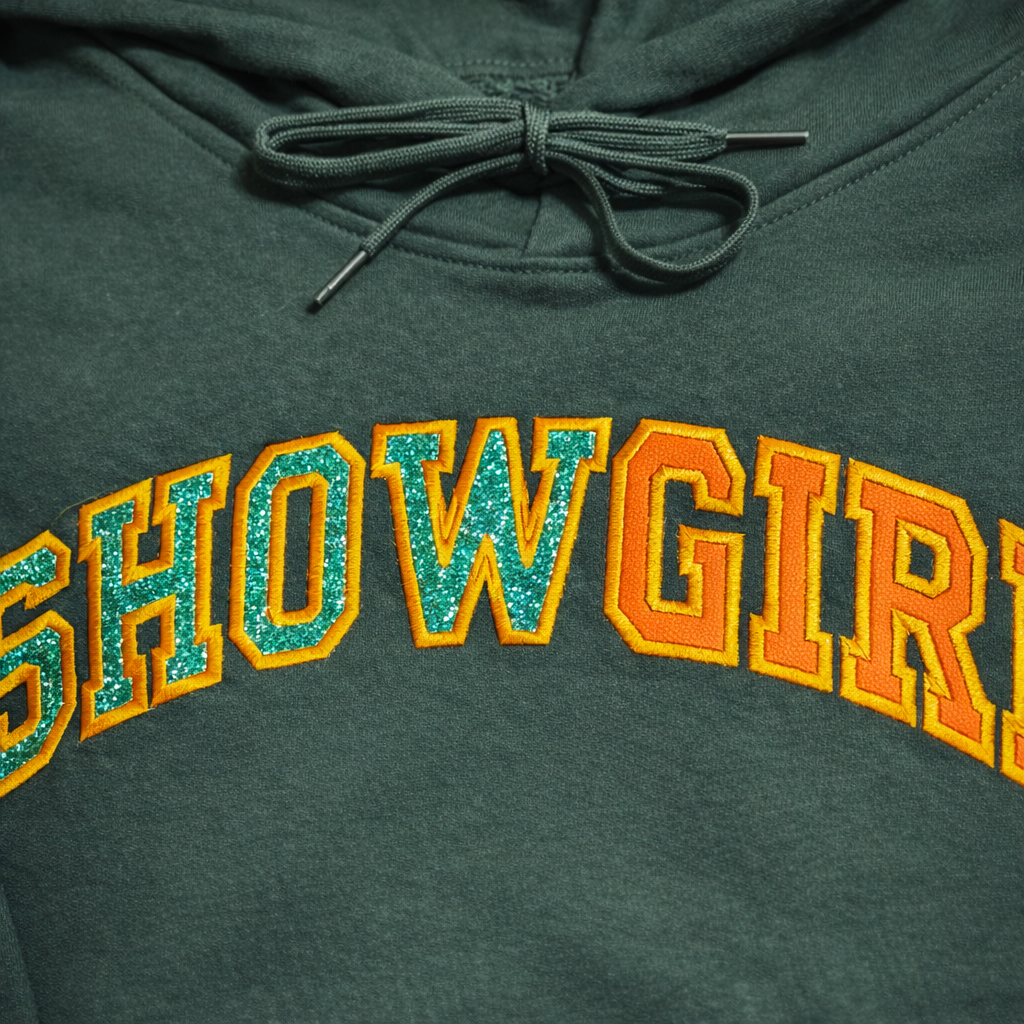Hoodie SHOWGIRL featuring bold applique embroidery in vibrant colors on a cozy fabric.