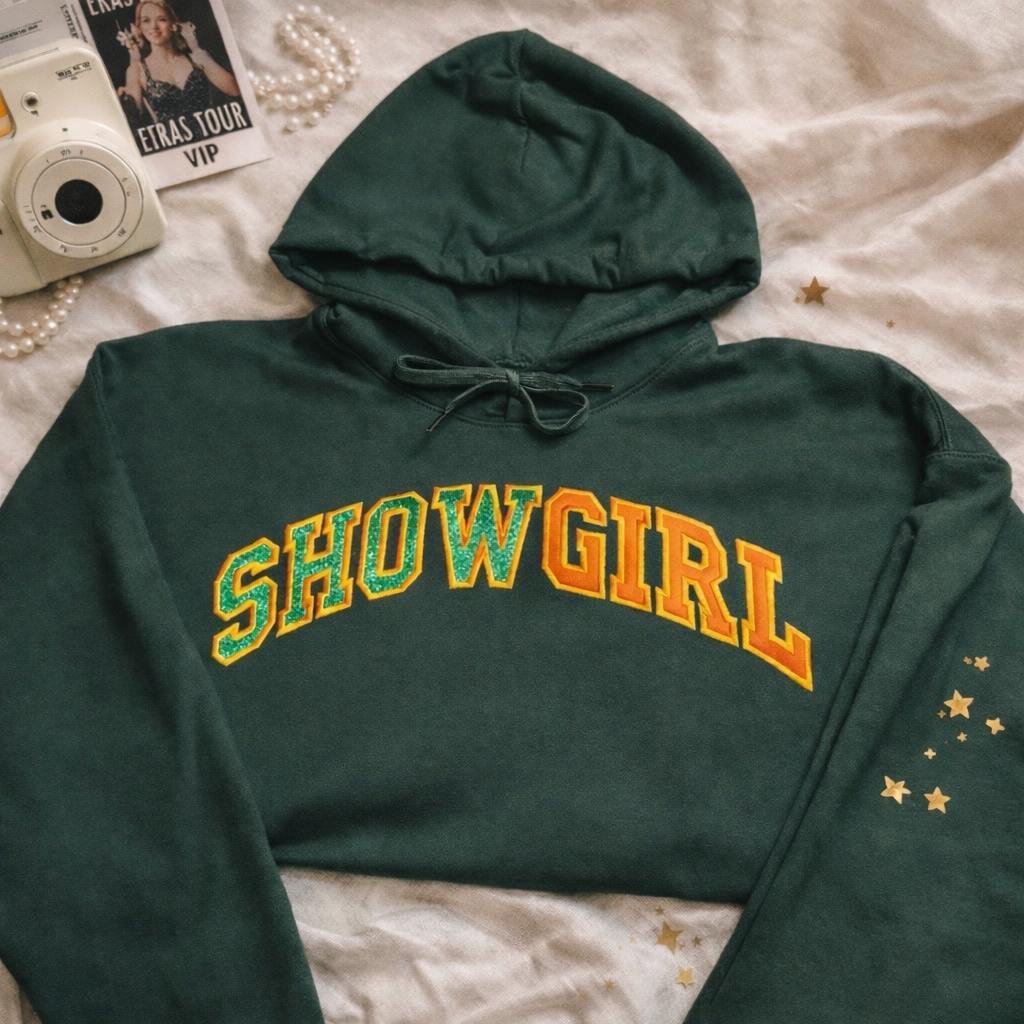 Hoodie SHOWGIRL with embroidered text on a cozy green fabric, perfect for casual wear and statement fashion.